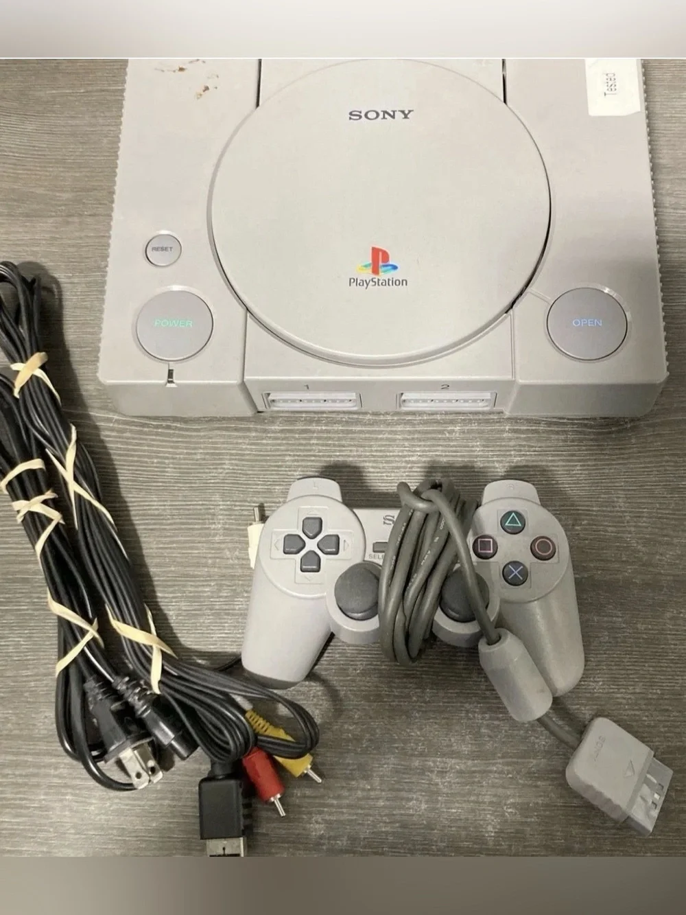 Sony Gray PlayStation Console with Matching Gray Controller and Cables